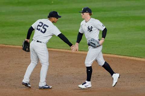 NEW YORK, NEW YORK - APRIL 06: Clint Frazier #77 high-fives Gleyber Torres #25 of the New York Yankees after their win during the ninth inning against the Baltimore Orioles at Yankee Stadium on April 06, 2021 in the Bronx borough of New York City. The Yankees won 7-2. (Photo by Sarah Stier/Getty Images)