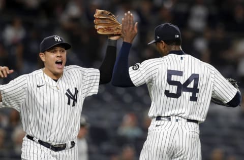 NEW YORK, NEW YORK - MAY 21: (NEW YORK DAILIES OUT) Gio Urshela #29 and Aroldis Chapman #54 of the New York Yankees react after a ninth inning triple play against the Chicago White Sox at Yankee Stadium on May 21, 2021 in New York City. The Yankees defeated the White Sox 2-1. (Photo by Jim McIsaac/Getty Images)