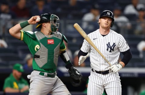 NEW YORK, NEW YORK - JUNE 18: Clint Frazier #77 of the New York Yankees reacts after being called out on strikes in the eighth inning as Sean Murphy #12 of the Oakland Athletics throws the ball down to third base at Yankee Stadium on June 18, 2021 in New York City. (Photo by Mike Stobe/Getty Images)