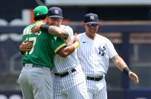 NEW YORK, NY - JUNE 19: Elvis Andrus #17 of the Oakland Athletics hugs Gleyber Torres #25 of the New York Yankees as Rougned Odor #18 of the Yankees looks on before a gameat Yankee Stadium on June 19, 2021 in New York City. (Photo by Rich Schultz/Getty Images)