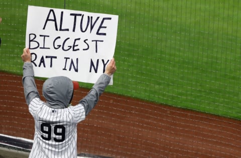 NEW YORK, NEW YORK - MAY 05: Fans hold signs during the game between the New York Yankees and the Houston Astros at Yankee Stadium on May 05, 2021 in New York City. (Photo by Mike Stobe/Getty Images)