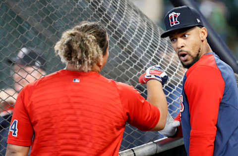 SEATTLE, WASHINGTON - JUNE 15: Willians Astudillo #64 shares in a moment with Byron Buxton #25 of the Minnesota Twins before the game against the Seattle Mariners at T-Mobile Park on June 15, 2021 in Seattle, Washington. (Photo by Steph Chambers/Getty Images)