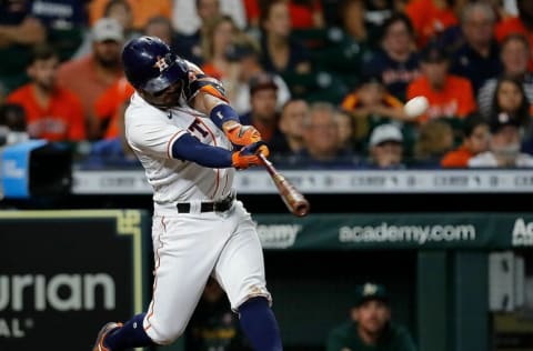 HOUSTON, TEXAS - JULY 07: Jose Altuve #27 of the Houston Astros hits a three run home run in the third inning against the Oakland Athletics at Minute Maid Park on July 07, 2021 in Houston, Texas. (Photo by Bob Levey/Getty Images)