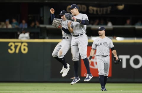 SEATTLE, WASHINGTON - JULY 07: Tim Locastro #33 and Aaron Judge #99 of the New York Yankees celebrate their 5-4 win against the Seattle Mariners at T-Mobile Park on July 07, 2021 in Seattle, Washington. (Photo by Steph Chambers/Getty Images)