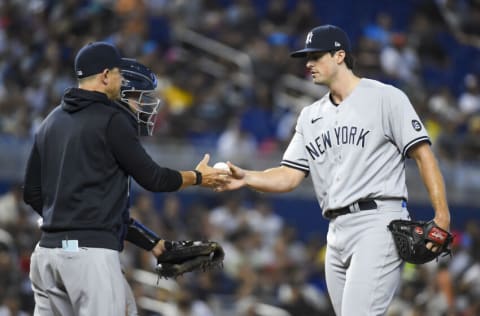 MIAMI, FL - AUGUST 01: Manager Aaron Boone #17 of the New York Yankees takes the baseball from Clay Holmes #35 during a pitching change in the seventh inning against the Miami Marlins at loanDepot park on August 1, 2021 in Miami, Florida. (Photo by Eric Espada/Getty Images)