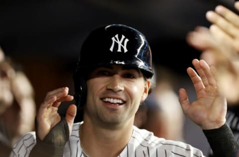 NEW YORK, NEW YORK - JUNE 22: Tyler Wade #14 of the New York Yankees is congratulated by teammates in the dugout after he scored on a wild pitch in the seventh inning against the Kansas City Royals at Yankee Stadium on June 22, 2021 in the Bronx borough of New York City. Wade was a pinch runner for Luke Voit. (Photo by Elsa/Getty Images)