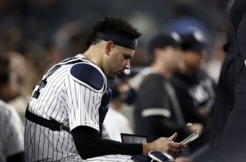 NEW YORK, NY - AUGUST 2: Gary Sanchez #24 of the New York Yankees looks at an Ipad in the dugout against the Baltimore Orioles during the fifth inning at Yankee Stadium on August 2, 2021 in New York City. (Photo by Adam Hunger/Getty Images)