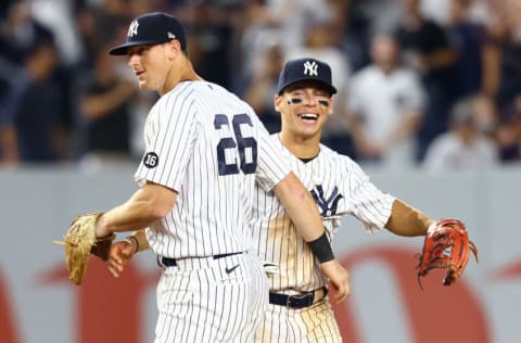 NEW YORK, NEW YORK - AUGUST 18: Andrew Velazquez #71 of the New York Yankees celebrates with DJ LeMahieu #26 after throwing out Kevin Plawecki #25 of the Boston Red Sox to end the game at Yankee Stadium on August 18, 2021 in New York City. New York Yankees defeated the Boston Red Sox 5-2. (Photo by Mike Stobe/Getty Images)