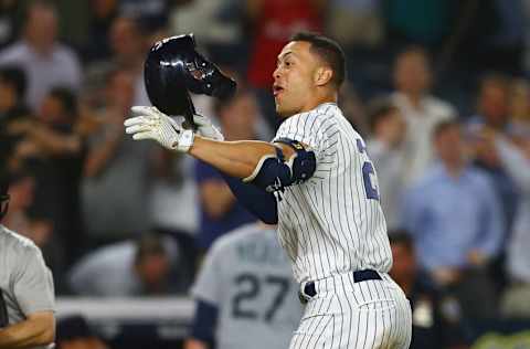 NEW YORK, NY - JUNE 20: Giancarlo Stanton #27 of the New York Yankees celebrates after hitting a walk-off 2-run home run in the bottom of the ninth inning against the Seattle Mariners at Yankee Stadium on June 20, 2018 in the Bronx borough of New York City. New York Yankees defeated the Seattle Mariners 7-5. (Photo by Mike Stobe/Getty Images)