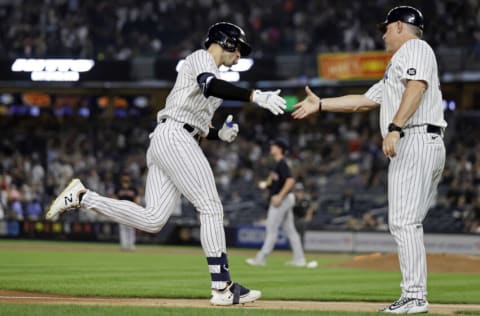 NEW YORK, NY - SEPTEMBER 17: Joey Gallo #13 of the New York Yankees is congratulated by Phil Nevin #88 as he rounds third base after hitting a home run off of Zach Plesac #34 of the Cleveland Indians during the second inning at Yankee Stadium on September 17, 2021 in New York City. (Photo by Adam Hunger/Getty Images)