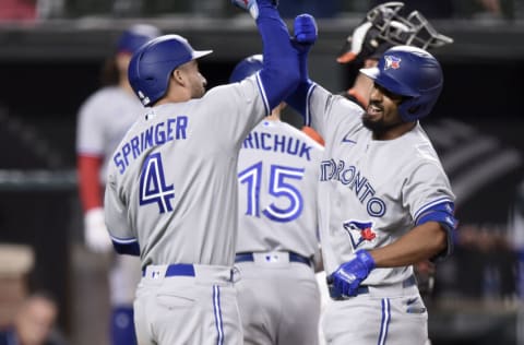 BALTIMORE, MARYLAND - SEPTEMBER 11: Marcus Semien #10 of the Toronto Blue Jays celebrates with George Springer #4 after hitting a three-run home run against the Baltimore Orioles during game two of a doubleheader at Oriole Park at Camden Yards on September 11, 2021 in Baltimore, Maryland. (Photo by Greg Fiume/Getty Images)