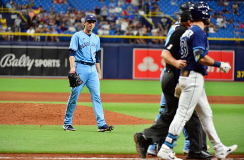 ST PETERSBURG, FLORIDA - SEPTEMBER 22: Ryan Borucki #56 of the Toronto Blue Jays walks towards Kevin Kiermaier #39 of the Tampa Bay Rays after hitting him with a pitch in the eighth inning at Tropicana Field on September 22, 2021 in St Petersburg, Florida. (Photo by Julio Aguilar/Getty Images)