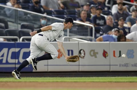 NEW YORK, NEW YORK - SEPTEMBER 22: DJ LeMahieu #26 of the New York Yankees can't come up with a ball hit for a fourth inning RBI single by Brock Holt of the Texas Rangers at Yankee Stadium on September 22, 2021 in New York City. (Photo by Jim McIsaac/Getty Images)