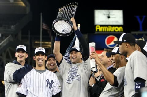 NEW YORK - NOVEMBER 04: Derek Jeter #2 of the New York Yankees holds up the trophy as he celebrates with A.J. Burnett (L), Jorge Posada (2nd L), Mariano Rivera (2nd R) and Robinson Cano after their 7-3 win against the Philadelphia Phillies in Game Six of the 2009 MLB World Series at Yankee Stadium on November 4, 2009 in the Bronx borough of New York City. (Photo by Jed Jacobsohn/Getty Images)