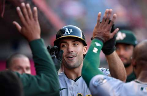 ANAHEIM, CA - SEPTEMBER 18: Matt Olson #28 of the Oakland Athletics gets high fives from his teammates in the dugout after hitting a one run home run during the first inning against starting pitcher Jose Suarez #54 of the Los Angeles Angels at Angel Stadium of Anaheim on September 18, 2021 in Anaheim, California. (Photo by Kevork Djansezian/Getty Images)