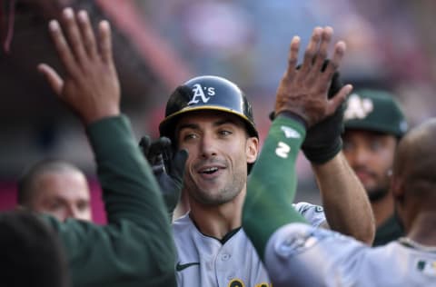 ANAHEIM, CA - SEPTEMBER 18: Matt Olson #28 of the Oakland Athletics gets high fives from his teammates in the dugout after hitting a one run home run during the first inning against starting pitcher Jose Suarez #54 of the Los Angeles Angels at Angel Stadium of Anaheim on September 18, 2021 in Anaheim, California. (Photo by Kevork Djansezian/Getty Images)