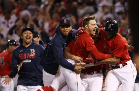 BOSTON, MASSACHUSETTS - OCTOBER 11: Enrique Hernandez #5 of the Boston Red Sox celebrates his game winning sacrifice fly with teammates in the ninth inning against the Tampa Bay Rays during Game 4 of the American League Division Series at Fenway Park on October 11, 2021 in Boston, Massachusetts. (Photo by Winslow Townson/Getty Images)