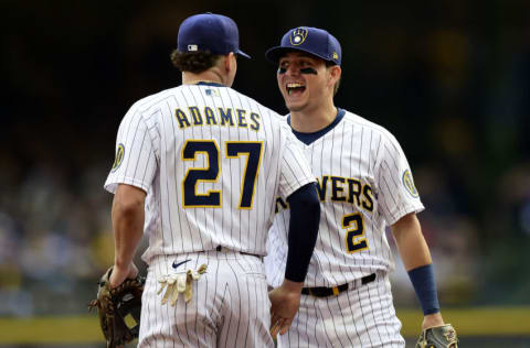 MILWAUKEE, WISCONSIN - OCTOBER 09: Willy Adames #27 and Luis Urias #2 of the Milwaukee Brewers celebrate a catch in the first inning during game 2 of the National League Division Series against the Atlanta Braves at American Family Field on October 09, 2021 in Milwaukee, Wisconsin. (Photo by Patrick McDermott/Getty Images)