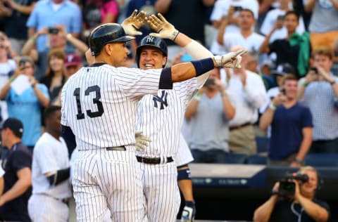 NEW YORK, NY - JUNE 19: Alex Rodriguez #13 of the New York Yankees celebreates with teammate Mark Teixeira #25 after hitting a solo home run in the first inning for his 3,000th career hit against the Detroit Tigers at Yankee Stadium on June 19, 2015 in the Bronx borough of New York City. (Photo by Mike Stobe/Getty Images)