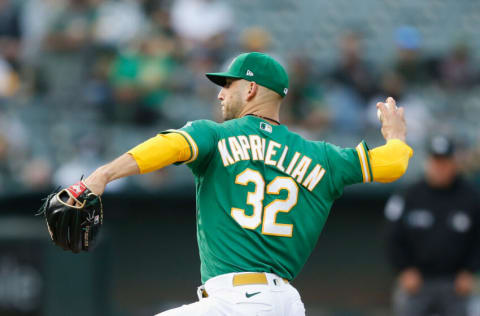 OAKLAND, CALIFORNIA - AUGUST 20: James Kaprielian #32 of the Oakland Athletics pitches in the top of the first inning against the San Francisco Giants at RingCentral Coliseum on August 20, 2021 in Oakland, California. (Photo by Lachlan Cunningham/Getty Images)