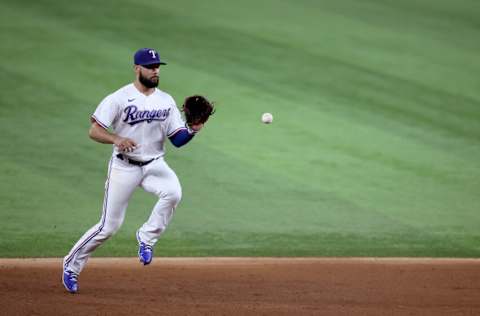 ARLINGTON, TEXAS - AUGUST 30: Isiah Kiner-Falefa #9 of the Texas Rangers fields a ground ball hit by Brendan Rodgers #7 of the Colorado Rockies in the top of the sixth inning at Globe Life Field on August 30, 2021 in Arlington, Texas. (Photo by Tom Pennington/Getty Images)