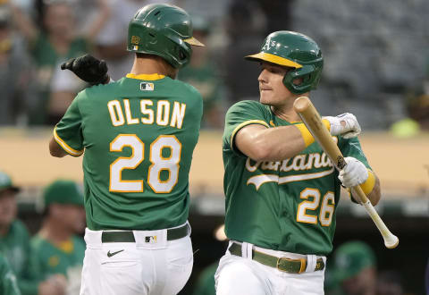 OAKLAND, CALIFORNIA – SEPTEMBER 21: Matt Olson #28 and Matt Chapman #26 of the Oakland Athletics celebrate after Olson hit a solo home run against the Seattle Mariners in the bottom of the first inning at RingCentral Coliseum on September 21, 2021 in Oakland, California. (Photo by Thearon W. Henderson/Getty Images)