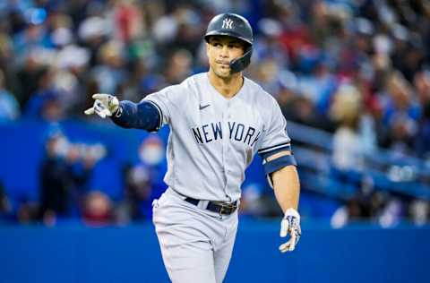 TORONTO, ONTARIO - SEPTEMBER 28: Giancarlo Stanton #27 of the New York Yankees gestures after hitting a three run home run against the Toronto Blue Jays in the seventh inning during their MLB game at the Rogers Centre on September 28, 2021 in Toronto, Ontario, Canada. (Photo by Mark Blinch/Getty Images)