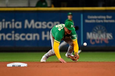 SEATTLE, WASHINGTON - SEPTEMBER 29: Matt Chapman #26 of the Oakland Athletics fails to handle the ball during the fifth inning against the Seattle Mariners at T-Mobile Park on September 29, 2021 in Seattle, Washington. (Photo by Alika Jenner/Getty Images)