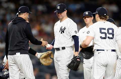 NEW YORK, NEW YORK - SEPTEMBER 22: Corey Kluber #28 of the New York Yankees hands the ball to manager Aaron Boone as he is removed from a game against the Texas Rangers in the fifth inning at Yankee Stadium on September 22, 2021 in New York City. (Photo by Jim McIsaac/Getty Images)