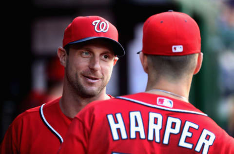 WASHINGTON, DC - MAY 28: Max Scherzer #31 of the Washington Nationals and Bryce Harper #34 talk in the dugout before the start of their game against the St. Louis Cardinals at Nationals Park on May 28, 2016 in Washington, DC. (Photo by Rob Carr/Getty Images)