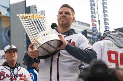 ATLANTA, GA - NOVEMBER 05: Freddie Freeman holds the Commissioner's Trophy as members of the Atlanta Braves celebrate following their World Series Parade at Truist Park on November 5, 2021 in Atlanta, Georgia. The Atlanta Braves won the World Series in six games against the Houston Astros winning their first championship since 1995. (Photo by Megan Varner/Getty Images)