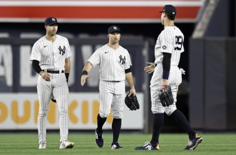 NEW YORK, NY - SEPTEMBER 17: Joey Gallo #13 of the New York Yankees, Brett Gardner #11 of the New York Yankees and Aaron Judge #99 of the New York Yankees celebrate after defeating the Cleveland Indians at Yankee Stadium on September 17, 2021 in New York City. The Yankees won 8-0. (Photo by Adam Hunger/Getty Images)