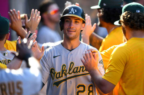 ANAHEIM, CA - SEPTEMBER 19: Matt Olson #28 of the Oakland Athletics is greeted in the dugout after scoring a run in the tenth inning of the game against the Los Angeles Angels at Angel Stadium of Anaheim on September 19, 2021 in Anaheim, California. (Photo by Jayne Kamin-Oncea/Getty Images)