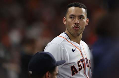 HOUSTON, TEXAS - OCTOBER 22: Carlos Correa #1 of the Houston Astros looks on from the dugout during the third inning against the Boston Red Sox in Game Six of the American League Championship Series at Minute Maid Park on October 22, 2021 in Houston, Texas. (Photo by Elsa/Getty Images)