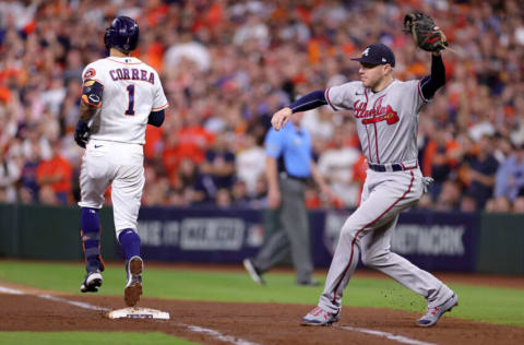 HOUSTON, TEXAS - NOVEMBER 02: Carlos Correa #1 of the Houston Astros is out at first base on a throw to Freddie Freeman #5 of the Atlanta Braves after striking out on a past ball during the sixth inning in Game Six of the World Series at Minute Maid Park on November 02, 2021 in Houston, Texas. (Photo by Carmen Mandato/Getty Images)