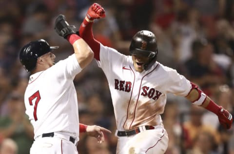 BOSTON, MA - AUGUST 24: Enrique Hernandez #5 of the Boston Red Sox reacts with Christian Vazquez #7 of the Boston Red Sox after hitting a two-run home run in the eighth inning of a game against the Minnesota Twins at Fenway Park on August 24, 2021 in Boston, Massachusetts. (Photo by Adam Glanzman/Getty Images)