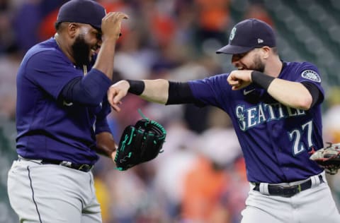 HOUSTON, TEXAS - JUNE 08: Diego Castillo #63 and Jesse Winker #27 of the Seattle Mariners celebrate defeating the Houston Astros 6-3 at Minute Maid Park on June 08, 2022 in Houston, Texas. (Photo by Carmen Mandato/Getty Images)