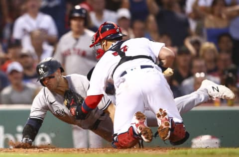 BOSTON, MA - JULY 08: Joey Gallo #13 of the New York Yankees is tagged out at home plate by Christian Vazquez #7 of the Boston Red Sox as he attempts to score an in-the-park home run in the third inning of a game at Fenway Park on July 8, 2022 in Boston, Massachusetts. (Photo by Adam Glanzman/Getty Images)