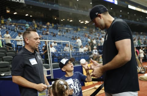 ST PETERSBURG, FLORIDA - JUNE 21: Joey Gallo #13 of the New York Yankees signs an autograph prior to the game against the Tampa Bay Rays at Tropicana Field on June 21, 2022 in St Petersburg, Florida. (Photo by Douglas P. DeFelice/Getty Images)