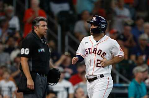 HOUSTON, TEXAS - JULY 21: Jose Altuve #27 of the Houston Astros scores in the first inning on a single by Alex Bregman against the New York Yankees during game one of a doubleheader at Minute Maid Park on July 21, 2022 in Houston, Texas. (Photo by Bob Levey/Getty Images)