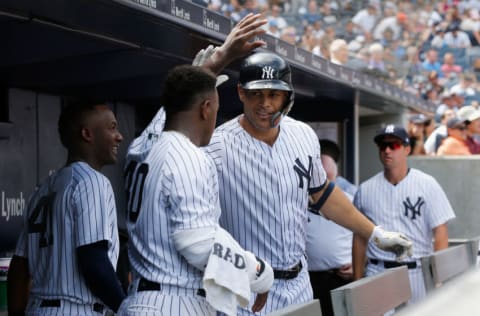 NEW YORK, NY - AUGUST 18: Giancarlo Stanton #27 of the New York Yankees celebrates his fourth inning home run against the Toronto Blue Jays with teammate Luis Severino #40 in the dugout at Yankee Stadium on August 18, 2018 in the Bronx borough of New York City. (Photo by Jim McIsaac/Getty Images)