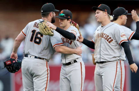 SAN DIEGO, CALIFORNIA - JULY 09: Mike Yastrzemski #5 and Joc Pederson #23 congratulate Carlos Rodon #16 of the San Francisco Giants after he pitched a complete game to defeat the San Diego Padres 3-1 in a game at PETCO Park on July 09, 2022 in San Diego, California. (Photo by Sean M. Haffey/Getty Images)