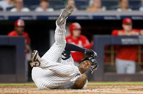 NEW YORK, NEW YORK - JULY 12: Aaron Hicks #31 of the New York Yankees reacts after he was hit with a foul tip during the third inning against the Cincinnati Reds at Yankee Stadium on July 12, 2022 in New York City. (Photo by Jim McIsaac/Getty Images)