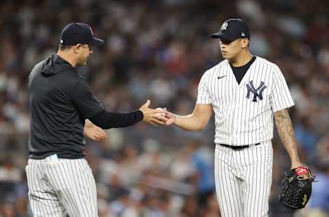 NEW YORK, NEW YORK - AUGUST 15: Jonathan Loaisiga #43 of the New York Yankees is taken off the mound by Manager Aaron Boone #17 during the eighth inning against the Tampa Bay Rays at Yankee Stadium on August 15, 2022 in the Bronx borough of New York City. The Rays won 4-0. (Photo by Sarah Stier/Getty Images)