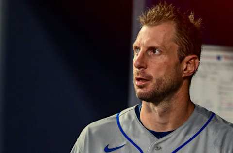 ATLANTA, GA - AUGUST 17: Max Scherzer #21 of the New York Mets looks on from the dugout against the Atlanta Braves at Truist Park on August 17, 2022 in Atlanta, Georgia. (Photo by Adam Hagy/Getty Images)