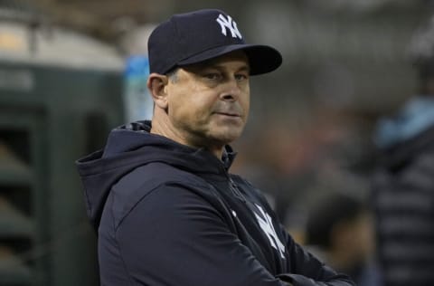 OAKLAND, CALIFORNIA - AUGUST 27: Aaron Boone #17 of the New York Yankees looks down into his bullpen against the Oakland Athletics in the bottom of the eighth inning at RingCentral Coliseum on August 27, 2022 in Oakland, California. (Photo by Thearon W. Henderson/Getty Images)