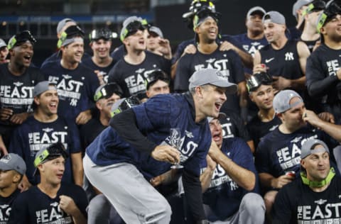 TORONTO, ON - SEPTEMBER 27: Manager Aaron Boone of the New York Yankees reacts alongside the team as they take a team photo on the mound after their MLB game against the Toronto Blue Jays, as they clinch the AL East, at Rogers Centre on September 27, 2022 in Toronto, Canada. (Photo by Cole Burston/Getty Images)