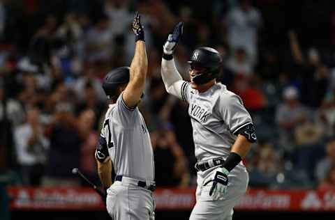 ANAHEIM, CALIFORNIA - AUGUST 29: Aaron Judge #99 of the New York Yankees celebrates his 50th home run of the season with Giancarlo Stanton #27 against the Los Angeles Angels during the eighth inning at Angel Stadium of Anaheim on August 29, 2022 in Anaheim, California. (Photo by Michael Owens/Getty Images)