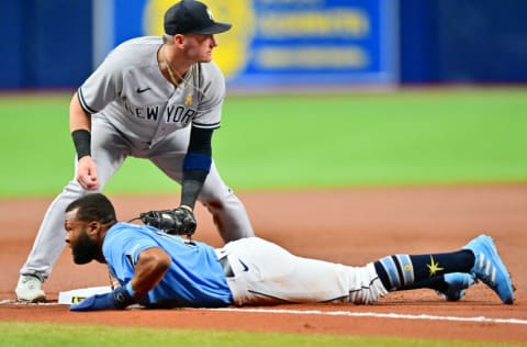 ST PETERSBURG, FLORIDA - SEPTEMBER 02: Manuel Margot #13 of the Tampa Bay Rays slides in safe under Josh Donaldson #28 of the New York Yankees during the first inning at Tropicana Field on September 02, 2022 in St Petersburg, Florida. (Photo by Julio Aguilar/Getty Images)