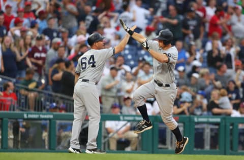 PHILADELPHIA, PA - JUNE 12: DJ LeMahieu #26 of the New York Yankees high fives coach Carlos Mendoza #64 after he hit a three-run home run to tie the game in the ninth inning against the Philadelphia Phillies at Citizens Bank Park on June 12, 2021 in Philadelphia, Pennsylvania. (Photo by Rich Schultz/Getty Images)